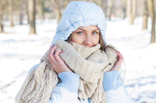 Image of snow scene with woman wearing warm clothing